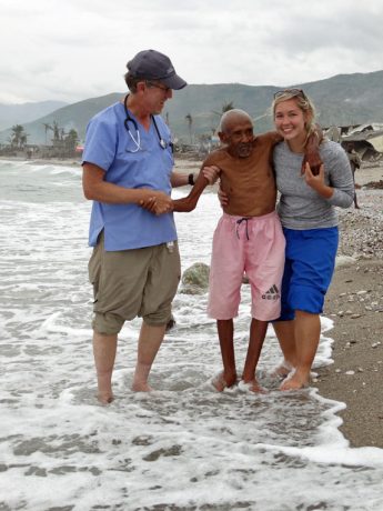 Dr. Mark and Erin helping Papi into the ocean