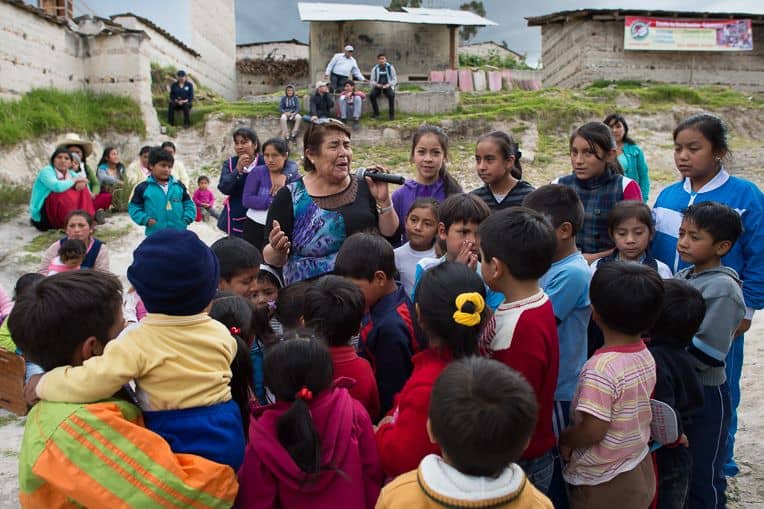 More than a dozen children stand and accept Jesus into their hearts.