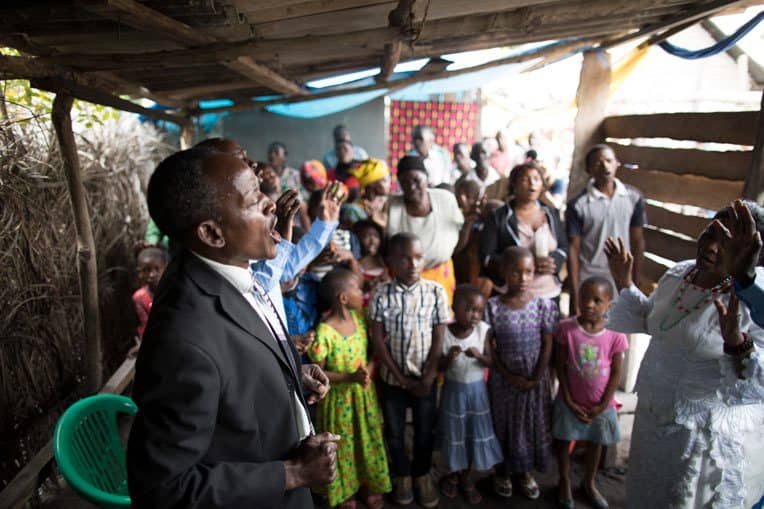 Pastor Marco Kayumbo celebrates with church members all that God is doing through Maranatha Church Kitomondo.