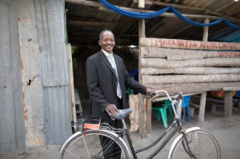 Pastor Marco Kayumbo rides his bike twice weekly to preach at his church plant, Maranatha Church Kitomondo.