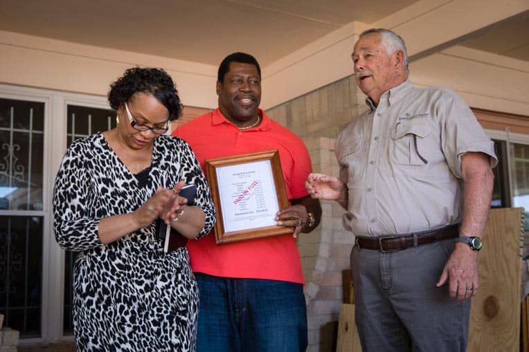 Program Manager Dan Burton welcomes the Dorseys to their home after more than seven months of living in hotels and apartments throughout Houston.