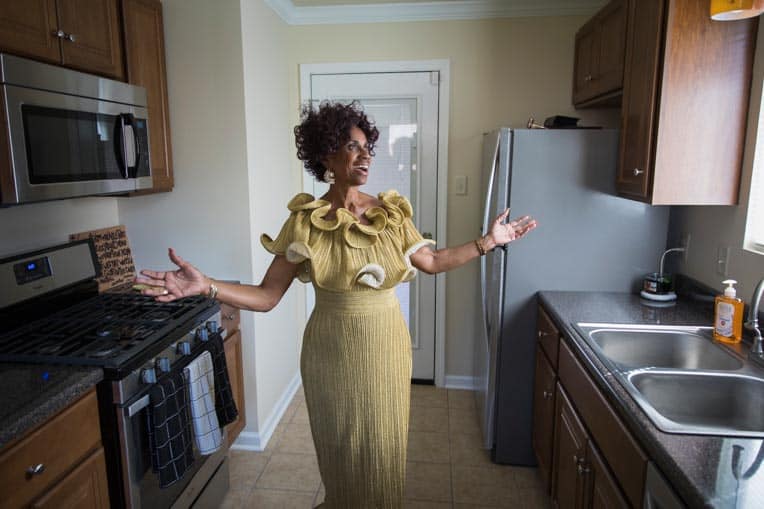 Ann Lamott is thankful for the work Samaritan's Purse volunteers did on her home. Grateful, she stands arms outstretched in her refurbished kitchen.