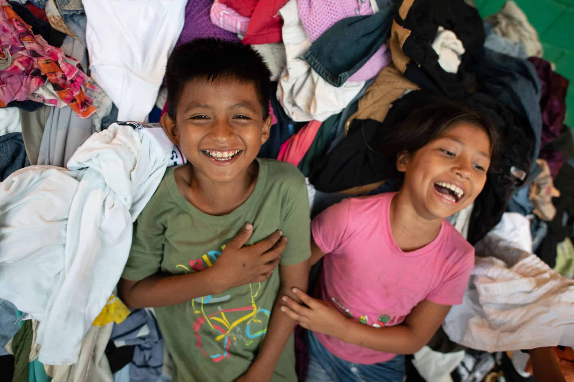 Even in a shelter stuff with belongings and supplies, there's still room for laughter after the volcano.