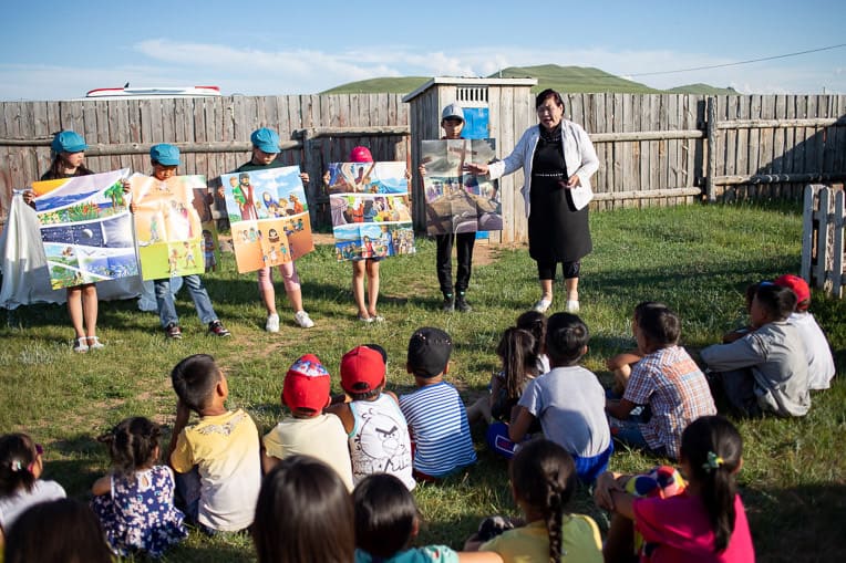 Tuya shares the Gospel before shoebox gifts are distributed at an Operation Christmas Child outreach event in Norovlin.