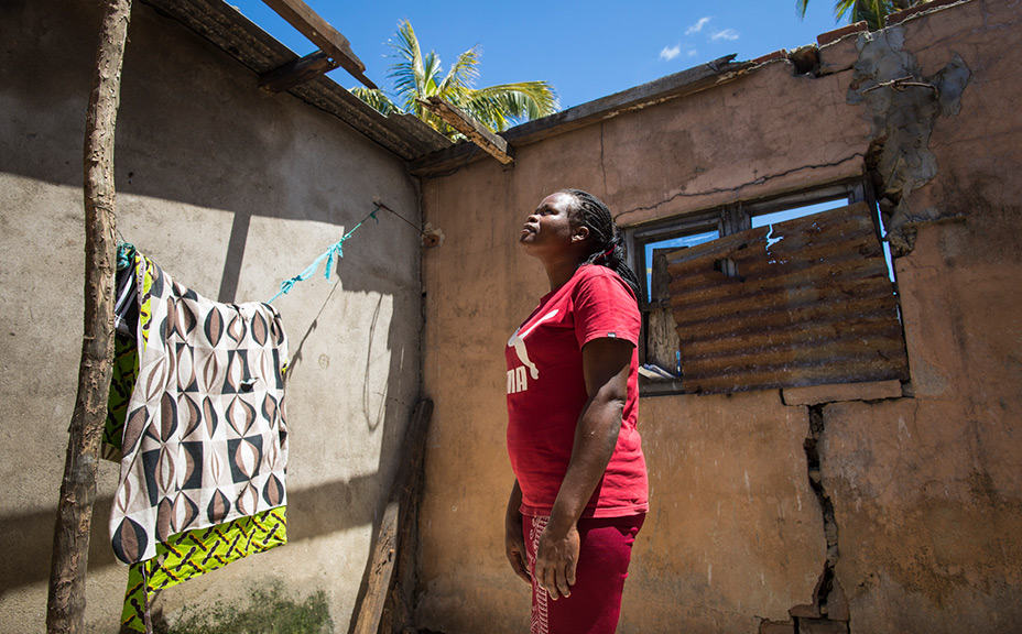 Lydia looks up to where her roof used to be, but is thankful to God for helping her start again.