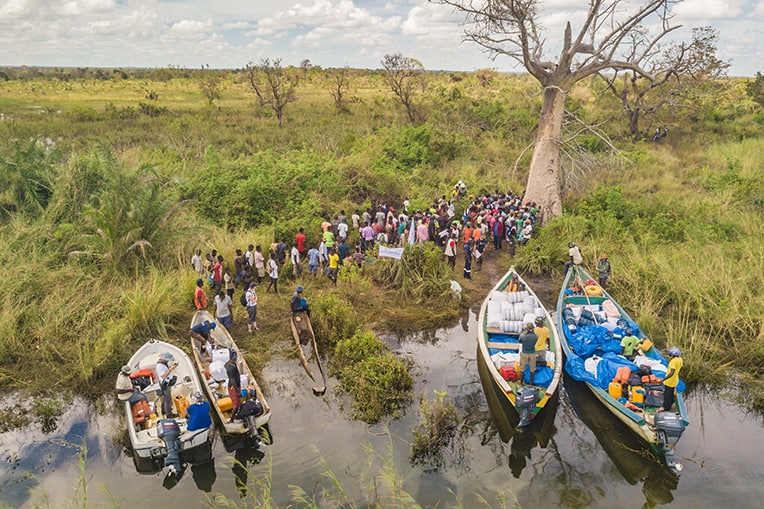 The roads into many communities were washed away. Our teams used boats to deliver tarps, water filtration kits, blankets, and solar lights.