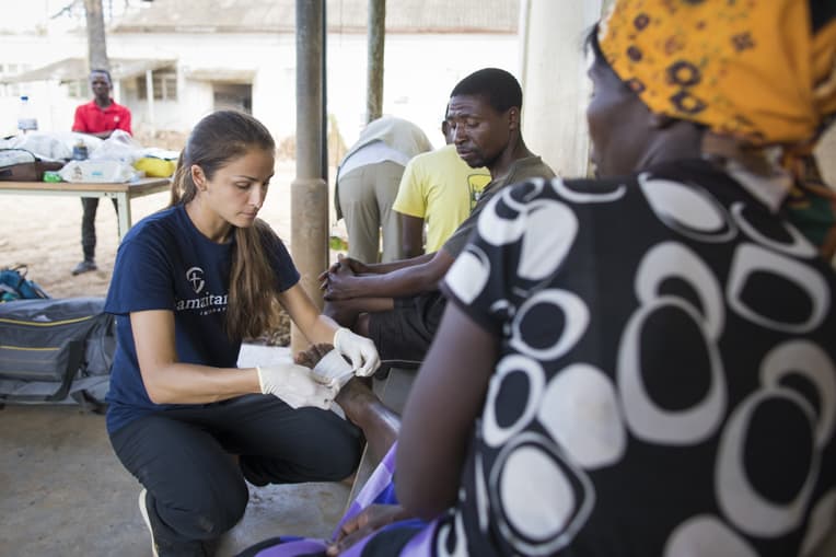 Jessica Lutz, a Samaritan's Purse nurse, cares for Juliet Luise, a widow. Her foot was cut during the cyclone by roof metal. "We are so grateful for Samaritan's Purse. We thank you so much for coming to visit us and give us medication."