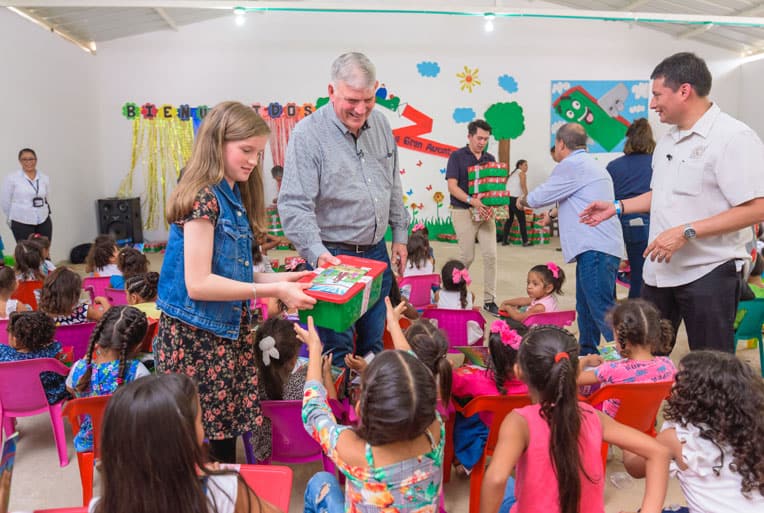 Franklin Graham and granddaughter Hannah help distribute gift-filled shoeboxes.