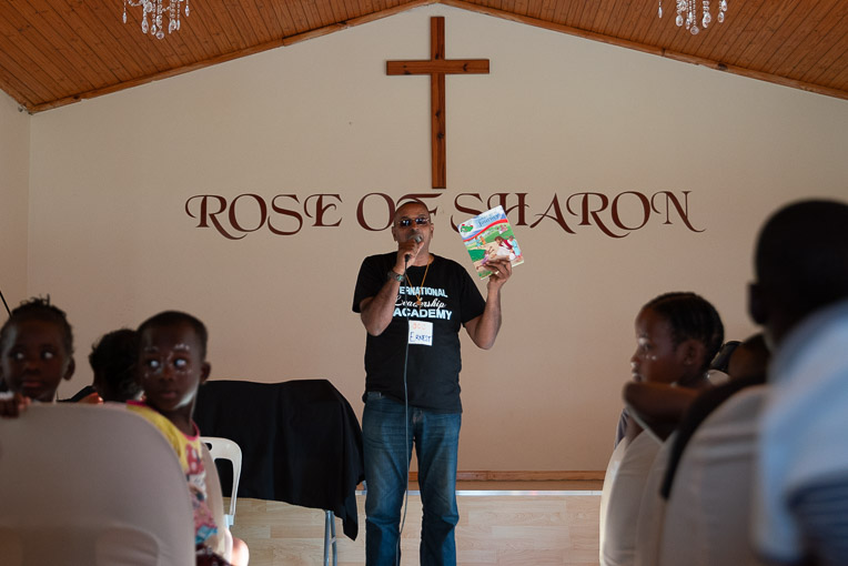 Pastor Ernest tells children of the love of God for them.