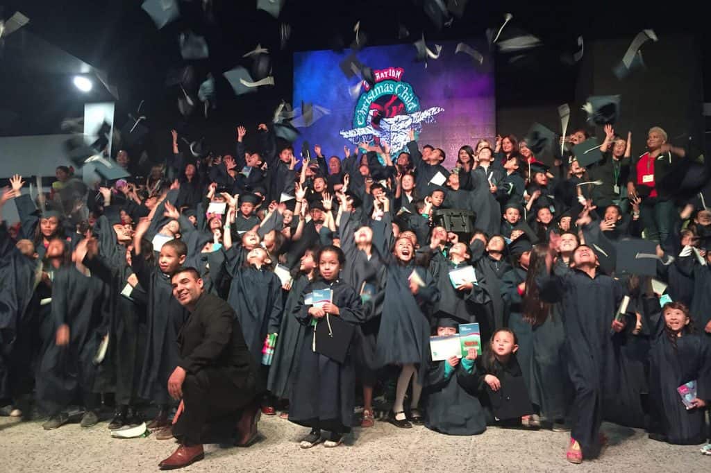 Dozens of children graduate from The Greatest Journey program in Colombia, receiving a certificate and a copy of the New Testament in Spanish.