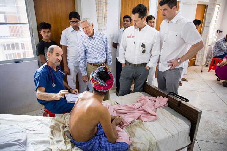 (From left) Dr. Stephen Kelley, Dr. Richard Furman, World Medical Mission Director Dr. Lance Plyler, and Edward Graham meet with a patient in the newly constructed hospital.