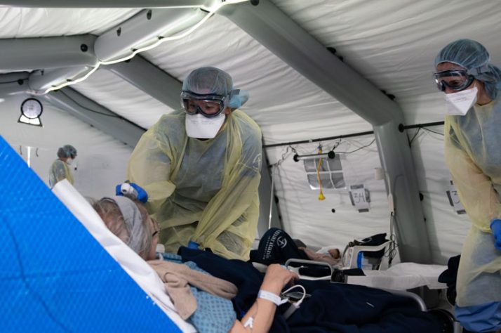 A nurse takes a patient's temperature.