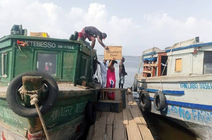 Cartons of gift-filled shoeboxes arrive on Vridi Ako via ferryboat.