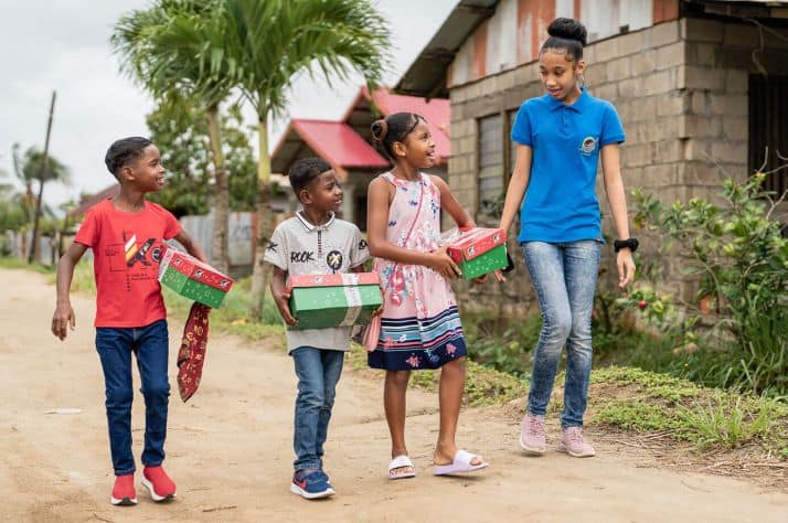 Charahja walks and talks with children who received Operation Christmas Child shoebox gifts in Suriname.