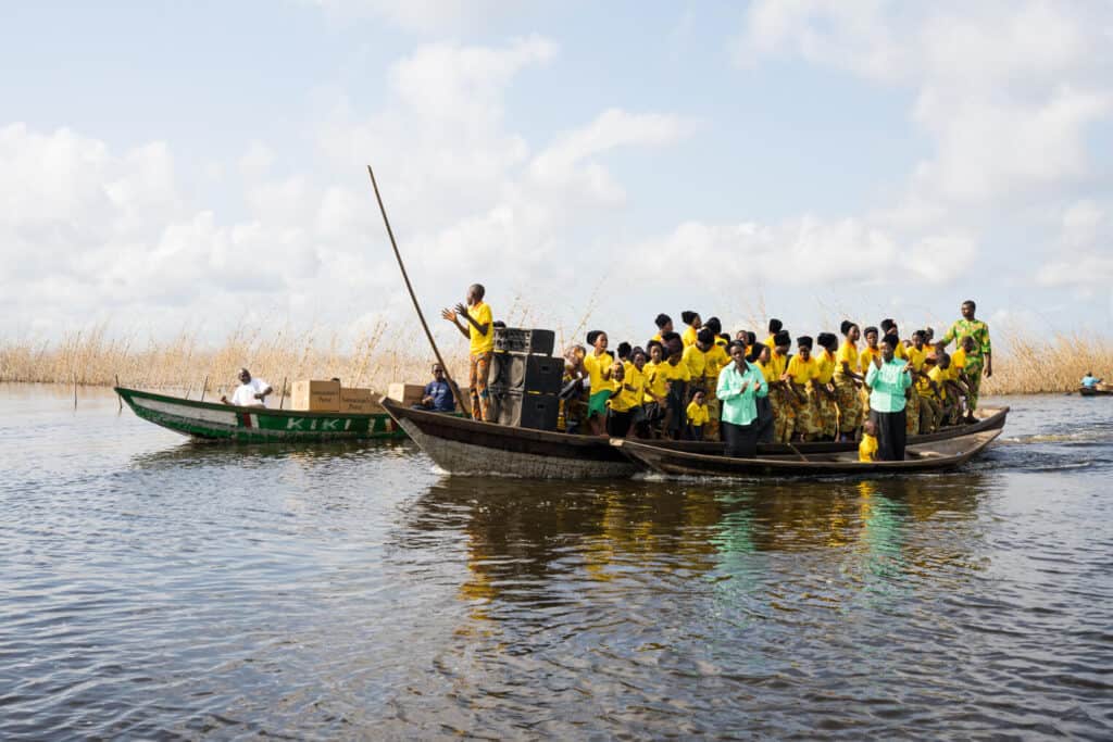 Children and teachers welcomed the team with a song aboard their boats.