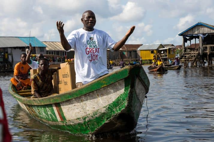 The only way to transport shoebox gifts to Ganvie is to cross Nokoue Lake in long wooden boats.