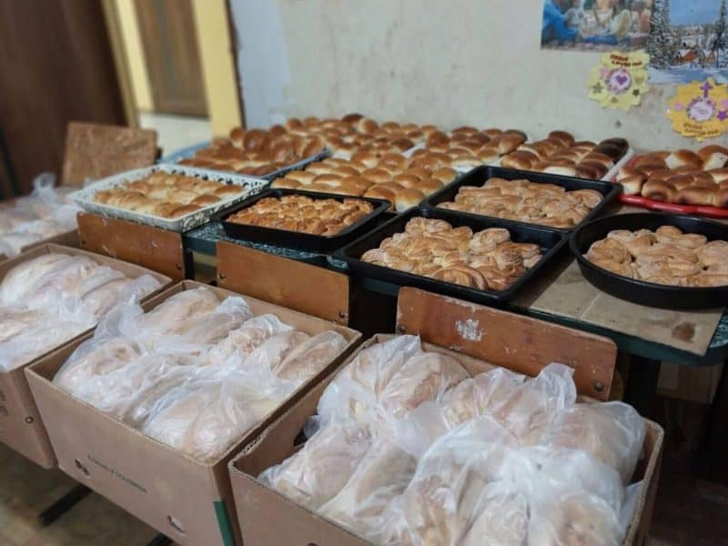 The congregation is distributing bread to nourish bodies and introduce people to the bread of life (John 6:35).