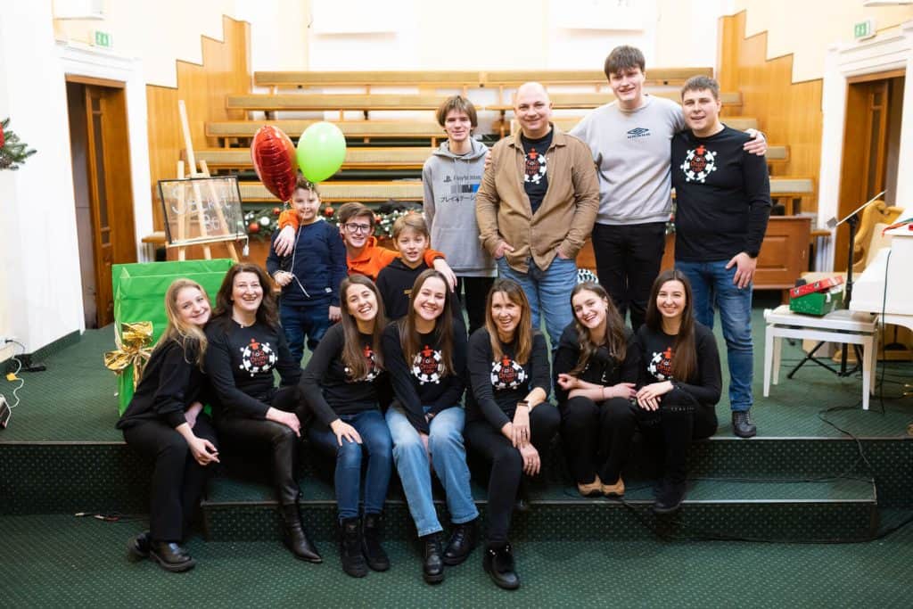 Pastor Fedir (in brown jacket) stands alongside his team that led shoebox outreach events this winter.