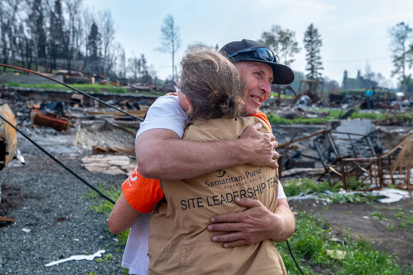 Volunteer comforting a survivor after a wildfire