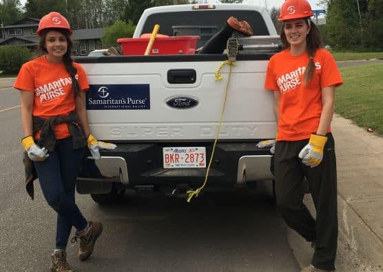 Andrea Hamilton and another Samaritan's Purse volunteer stand next to truck