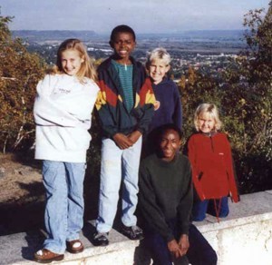 On their Choir tour in 1999, Alex (second from left) and his friend Alphonse spent three days with a family in Minnesota. In 2003, the boys were sponsored by that family to come to the United States for an education.