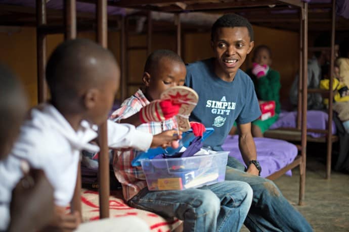 In one of his old bedrooms at Gisimba Memorial Center, Alex visits with boys who currently live at the orphanage as they explore the treasures in their shoebox gifts.