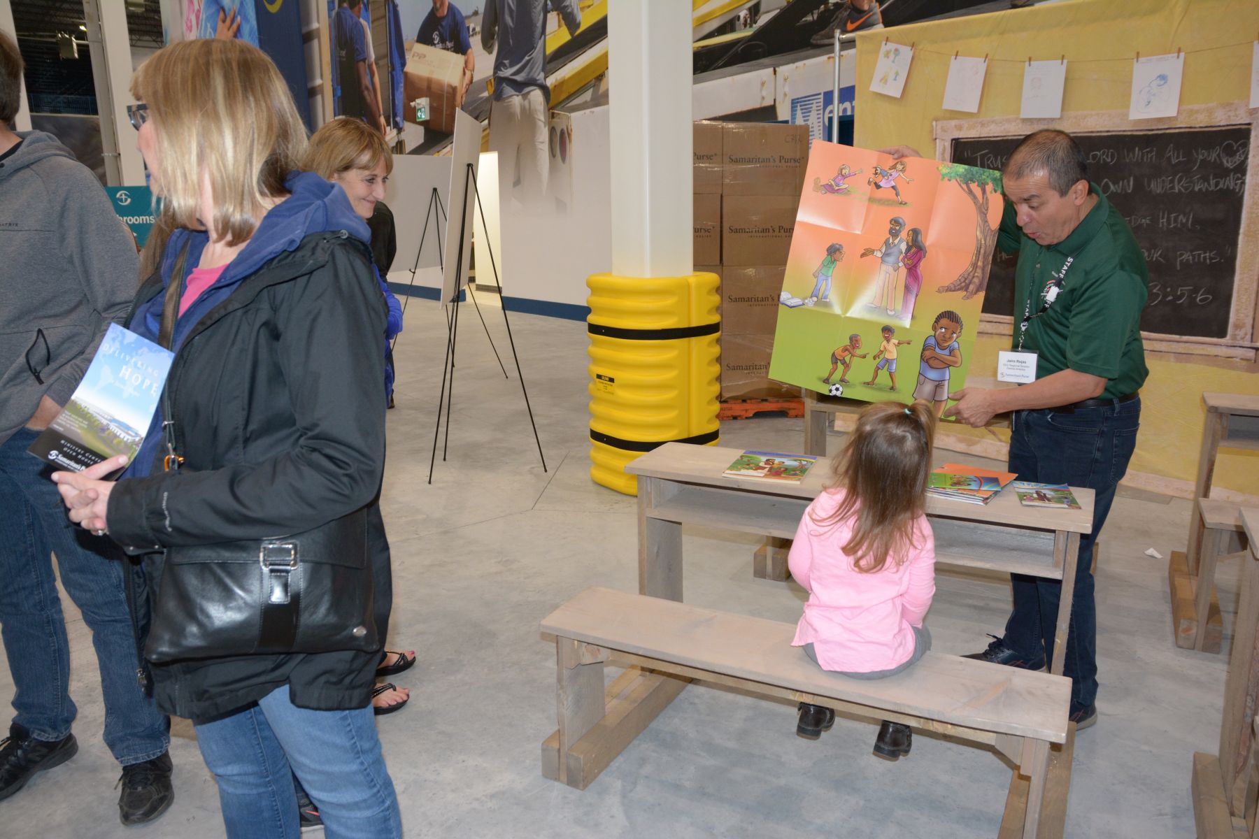 A child gets the basics of following Jesus during an impromptu presentation of The Greatest Journey. It's a 12-lesson Samaritan's Purse evangelism and discipleship program offered to children who have received Operation Christmas Child gift-filled shoeboxes.