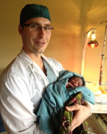 Dr. Ginther holding baby