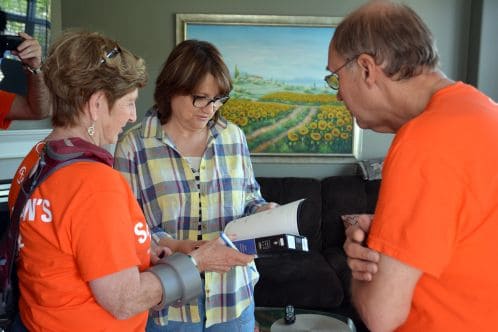 Volunteer giving Bible to Fort McMurray homeowner