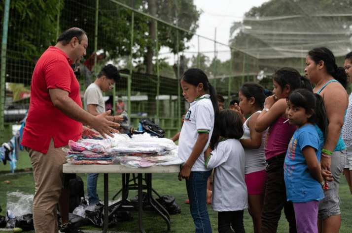 Families receive clothing at a distribution with local partners.