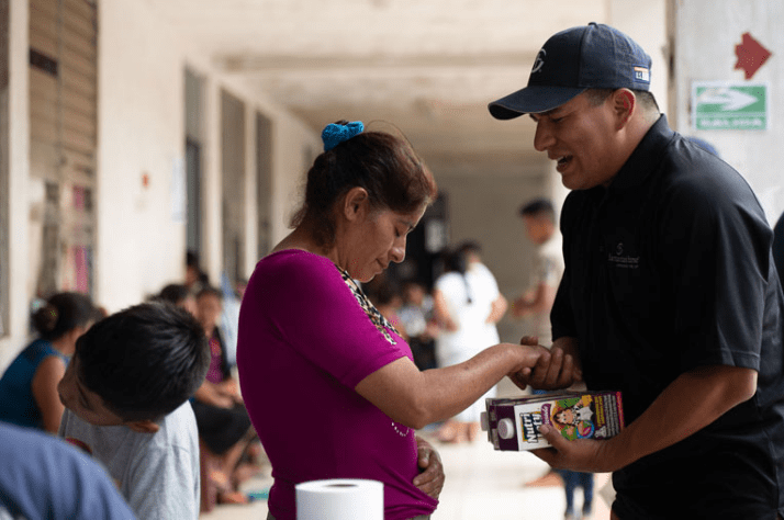 Angel Jordan spends time praying with hurting families during a food distribution.