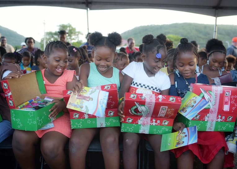 Children in Antigua open their shoeboxes with delight!