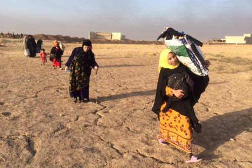 Female refugee walking with relief items