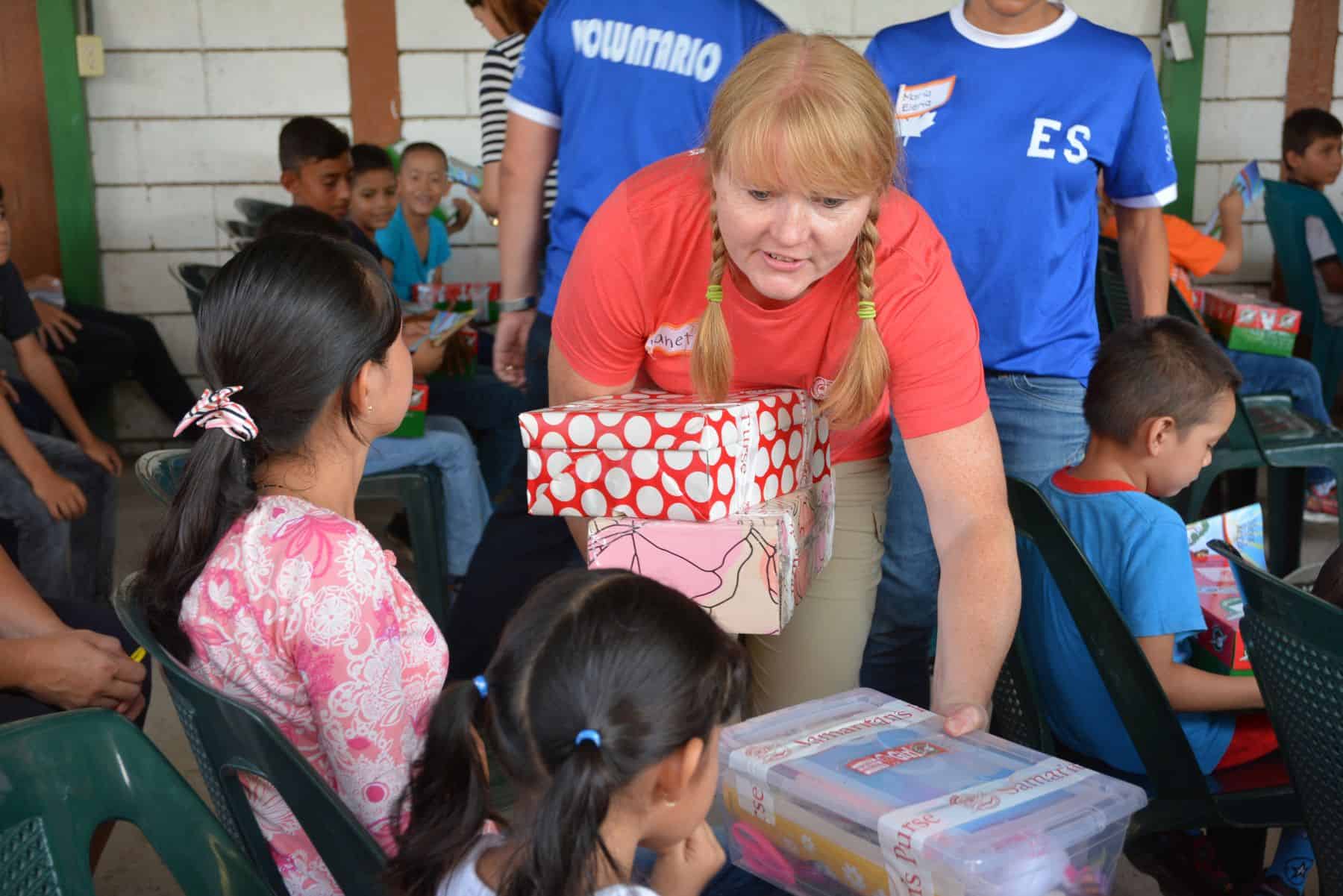 Calgarian Janet Olmstead hands out shoebox gifts at a distribution in El Salvador.