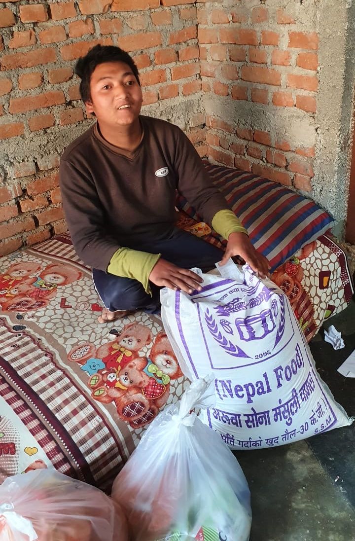 Manish welcomes a delivery of emergency food to help his family in Nepal survive the coronavirus pandemic.