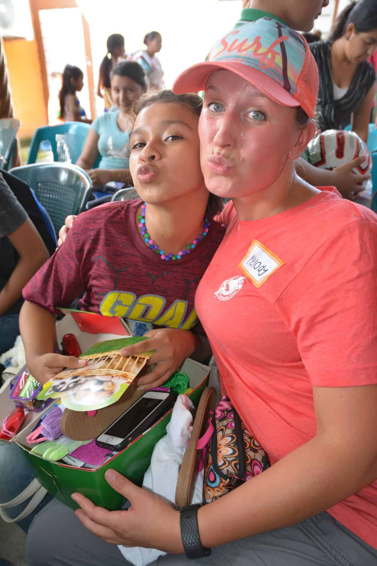 Melody Borgstrom and her shoebox recipient have fun posing for the camera.