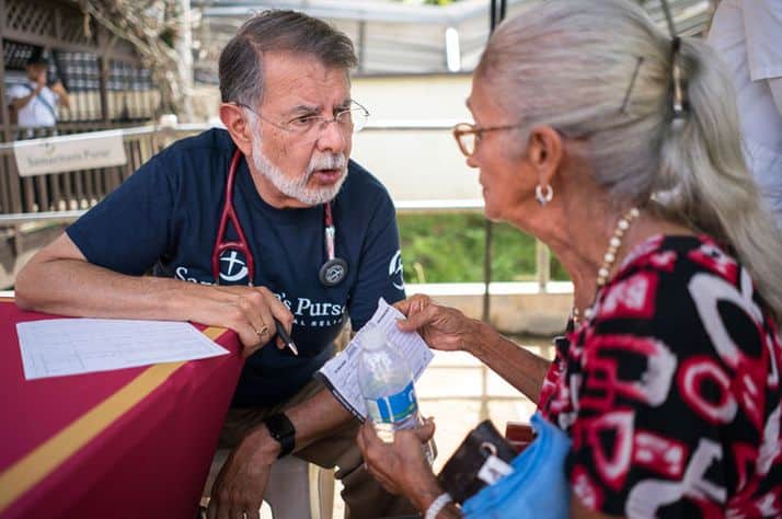 Dr. Carlos de la Garza consults with a patient in rural Puerto Rico.