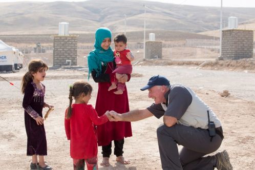 Samaritan's Purse staff shakes hand of refugee girl