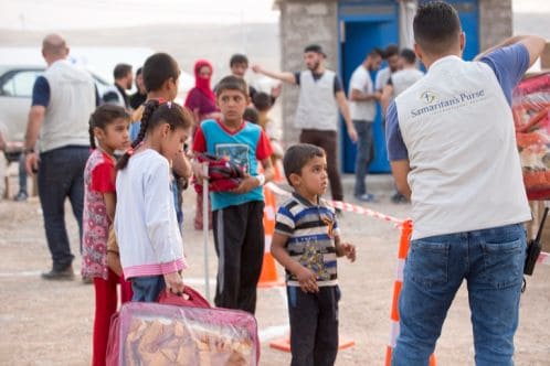Refugee children and Samaritan's Purse staff