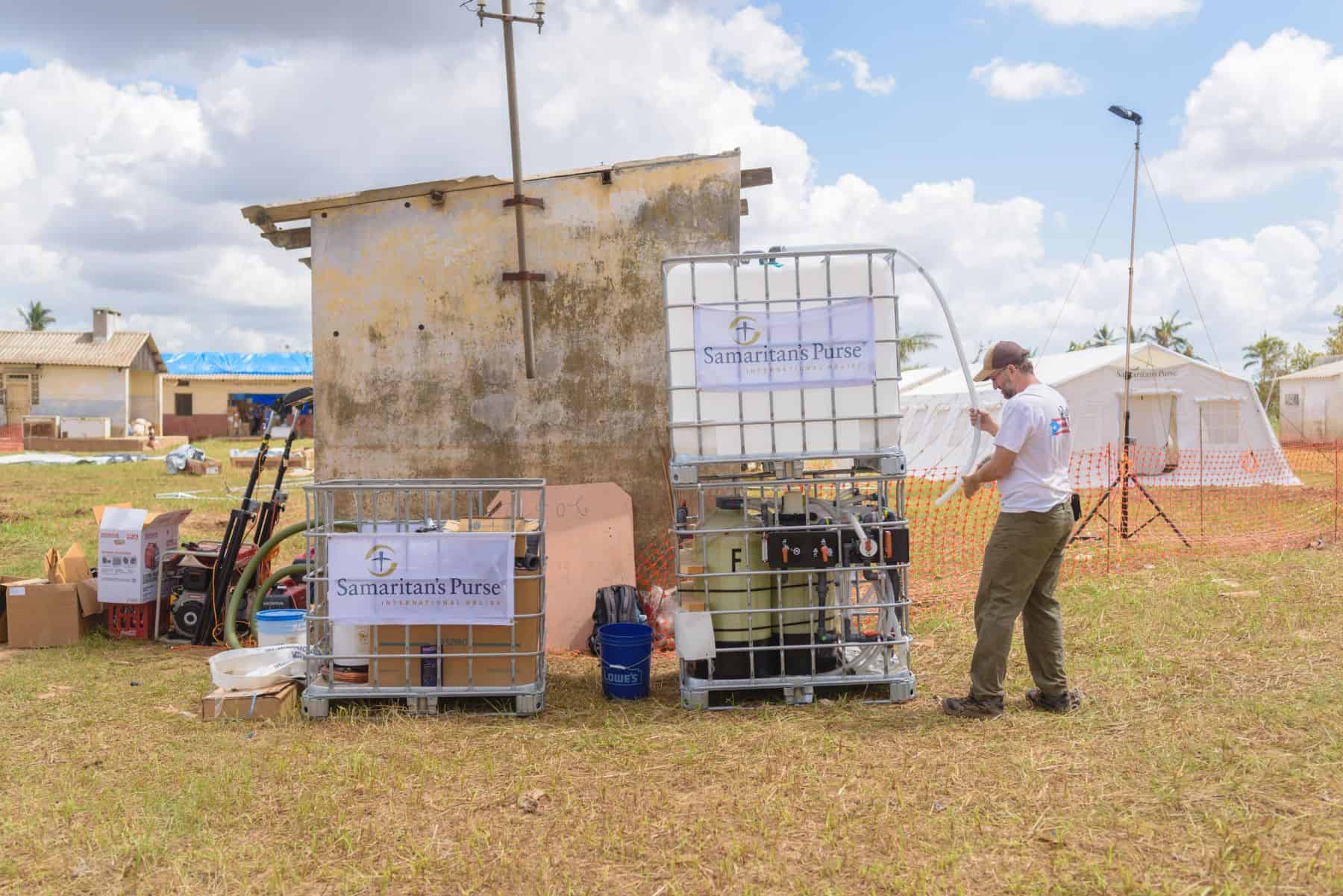 Canadian, Peter Roebuck, sets up a water treatment system in Mozambique. Peter is from Ottawa and is serving as the WASH (Water, Sanitation & Hygiene) lead for the team. The Emergency Field Hospital can be seen in the background.