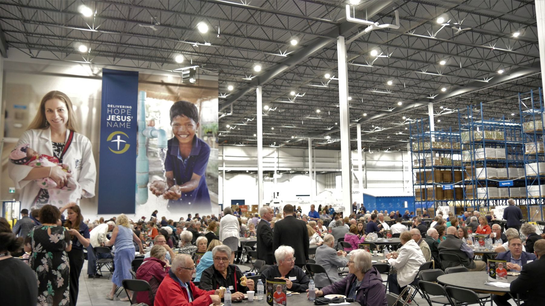 Guests enjoyed a meal at a temporary cafeteria set up in the new warehouse for the dedication and open house.