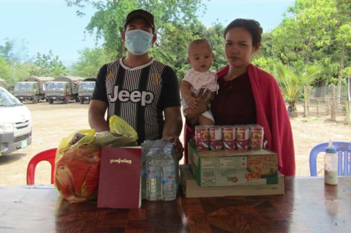 Life-saving provision: Tieng (left) and Saroeurn (right) were relieved to receive emergency food, including milk for their daughter, to help sustain them through the Coronavirus pandemic. They also took a Bible.