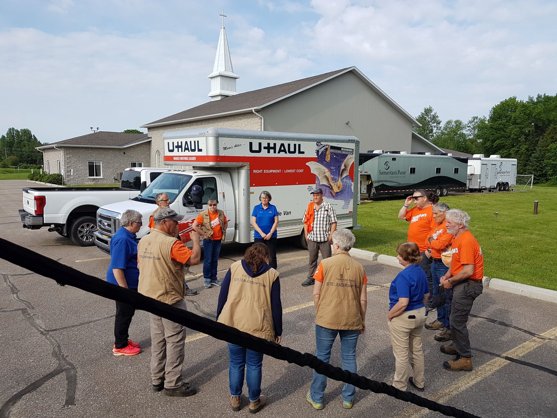 Samaritan's Purse volunteers pray with Billy Graham Rapid Response Team chaplains in Renfrew County, Ontario, pray before beginning their day of serving flood victims in Jesus’ Name.