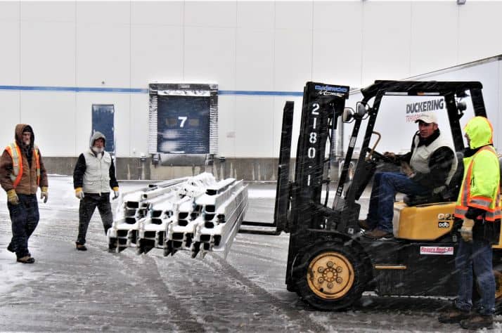 Samaritan's Purse team members load materials from a forklift on a flatbed truck. The truck will travel to North Carolina where the much-needed materials will be flown to Antigua via the non-profit’s DC-8 cargo plane and finally transported by barge to Barbuda.