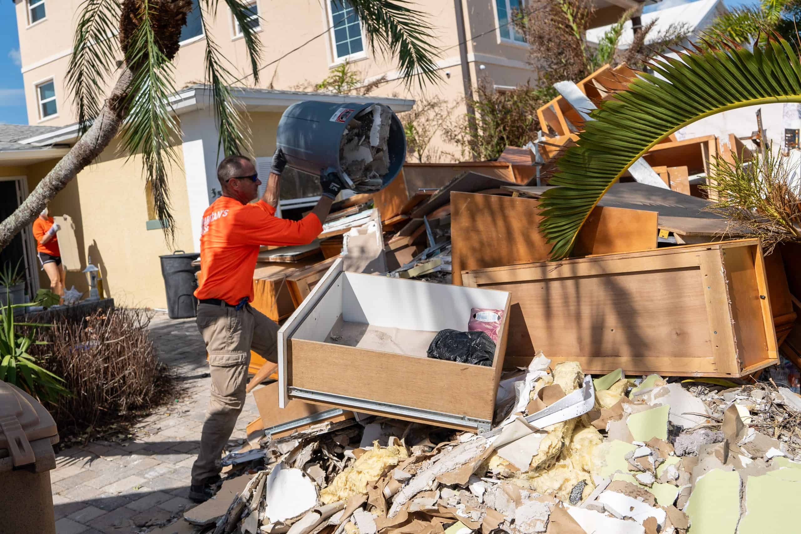 Volunteers remove debris from Dale and Tracy’s home.