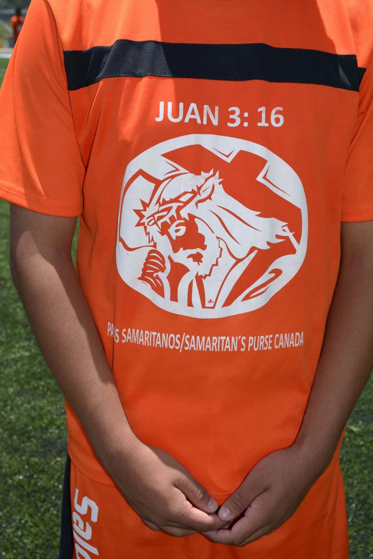 The shirt that each soccer player receives has a caricature of Jesus Christ and a prominent mention of John 3:16.