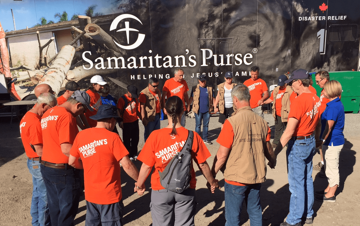 Samaritan's Purse site leadership team and volunteers, along with chaplains from the Billy Graham Evangelistic Association, come together to pray to start the day in Grand Forks, B.C..