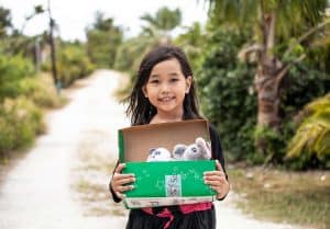 A shoebox recipient on the Pacific island of Saipan proudly shows off the gifts she received.