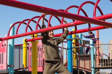 Displaced Yazidi children enjoy the playground at the Northern Iraq Community Center